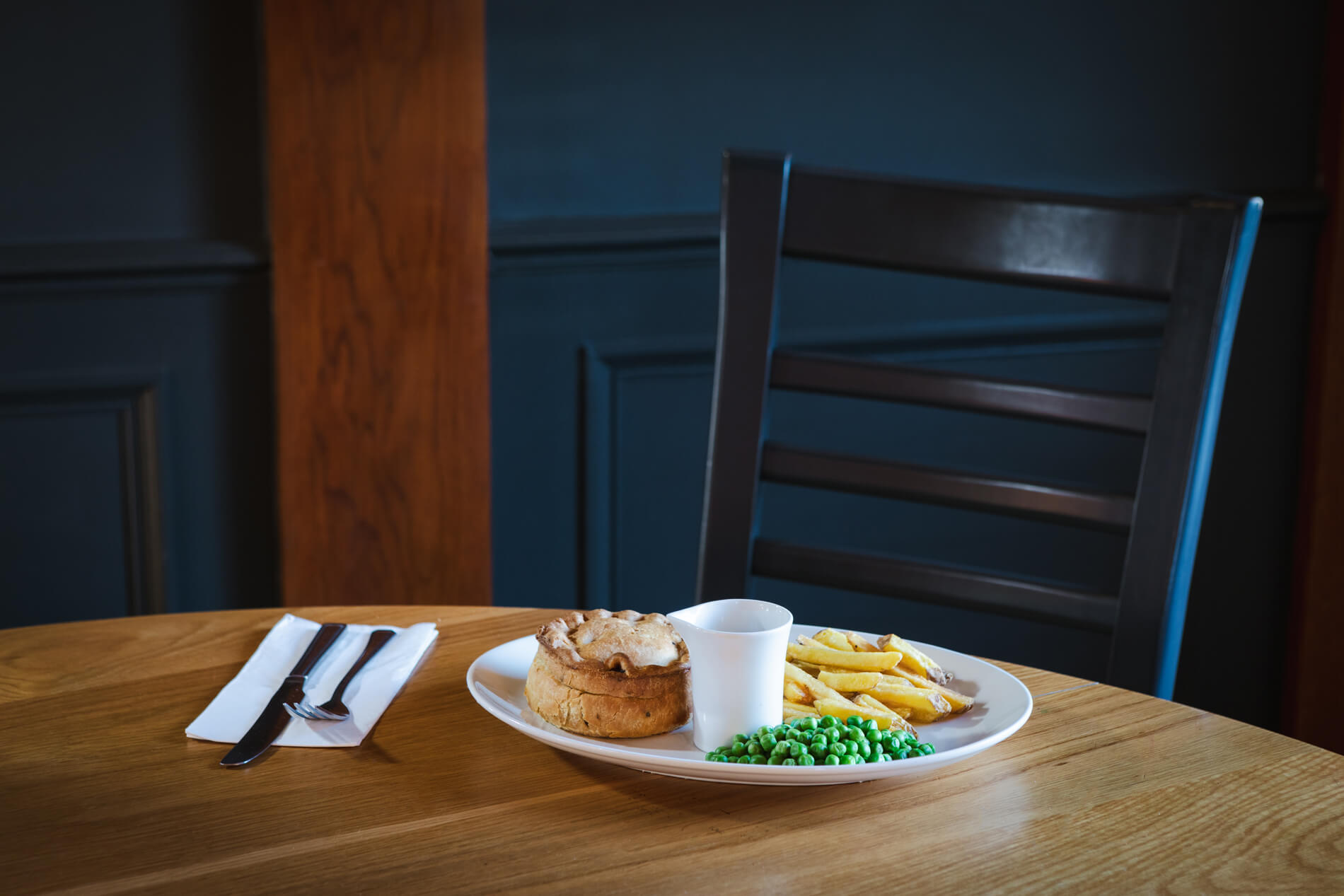 Beef and ale pie with chips, peas, and gravy