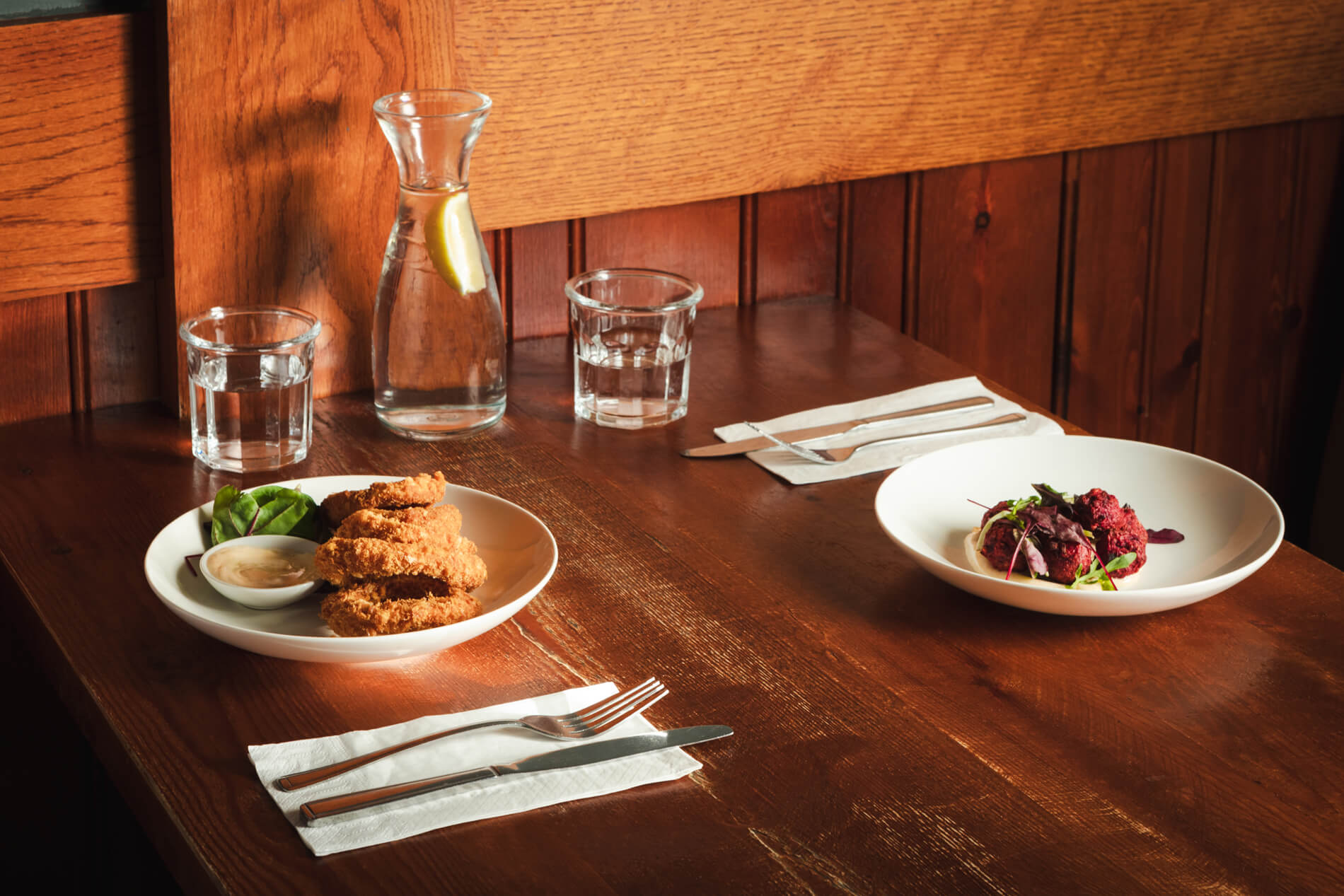 Dining table with cooked meals and cutlery